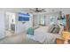 Bright primary bedroom offering wood-look floors, modern ceiling fan, and ensuite bath access at 7401 Purser Ln, Hanahan, SC 29410