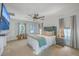 Spacious primary bedroom with a ceiling fan, modern decor, and access to a private balcony at 7401 Purser Ln, Hanahan, SC 29410