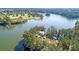 Aerial view of a lakeside home surrounded by lush greenery and a serene lake, offering a private and tranquil setting at 778 Clay Field Trl, Summerville, SC 29485