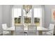 Bright dining room with large windows offering scenic views and a designer chandelier at 778 Clay Field Trl, Summerville, SC 29485