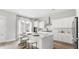 Modern kitchen boasts a large island with seating and sleek, white cabinetry at 778 Clay Field Trl, Summerville, SC 29485