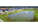 Scenic pond with a fountain and new construction homes in the background, offering a picturesque community view at 778 Clay Field Trl, Summerville, SC 29485