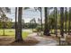 Picturesque walking trail winding through a wooded area with benches, offering a peaceful outdoor experience at 778 Clay Field Trl, Summerville, SC 29485