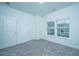 Bright, neutral bedroom with carpet, two windows, and two doors, perfect for relaxation at 902 Twin Rivers Drive, Wando, SC 29492