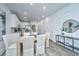 Dining area with a wooden table, upholstered chairs, and an open view to the modern kitchen at 902 Twin Rivers Drive, Wando, SC 29492