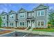 Stylish townhomes display a modern gray facade, complemented by manicured landscaping and bright entryways at 902 Twin Rivers Drive, Wando, SC 29492
