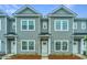 Attractive townhomes feature gray siding, bright white trim, and neatly landscaped front yards at 902 Twin Rivers Drive, Wando, SC 29492