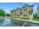 New townhomes with tan siding and dark roofs, well-kept landscaping and ample parking spots at 902 Twin Rivers Drive, Wando, SC 29492