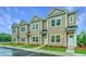 Well-maintained townhomes feature neutral tan siding, black roofs, and meticulously kept lawns at 902 Twin Rivers Drive, Wando, SC 29492