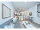 Open-concept living spaces showing a dining area, living room, and staircase in a modern style at 902 Twin Rivers Drive, Wando, SC 29492