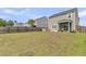 Sprawling green backyard featuring a wooden fence, screened-in porch and view of the home's exterior at 9706 Fanning Basket Ln, Ladson, SC 29456