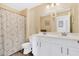 Bright bathroom featuring double vanity, framed mirrors, and decorative shower curtain with a shower and toilet at 9706 Fanning Basket Ln, Ladson, SC 29456