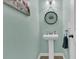 Charming bathroom features pedestal sink, beachy decor, and a soothing coastal color palette at 9706 Fanning Basket Ln, Ladson, SC 29456