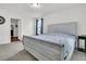 Bedroom boasts neutral-toned carpet, a queen bed, and access to a walk-in closet at 9706 Fanning Basket Ln, Ladson, SC 29456