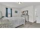 This bedroom boasts neutral-toned carpet, a queen bed, a chest of drawers, and natural light at 9706 Fanning Basket Ln, Ladson, SC 29456