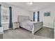 Bedroom features a cozy bed, window with natural light, and neutral-toned carpet flooring at 9706 Fanning Basket Ln, Ladson, SC 29456