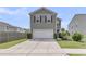 Two-story home featuring a two-car garage, neutral siding, and well-maintained landscaping at 9706 Fanning Basket Ln, Ladson, SC 29456