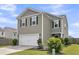 Well-kept two-story home showcasing a two-car garage, stylish siding, and neat landscaping at 9706 Fanning Basket Ln, Ladson, SC 29456