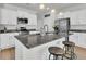 Kitchen island with granite countertop, pendant lights, stainless appliances, open to the dining area at 9706 Fanning Basket Ln, Ladson, SC 29456