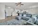 Bright open floor plan connecting kitchen, staircase, and living room, complete with modern decor and comfortable seating at 9706 Fanning Basket Ln, Ladson, SC 29456