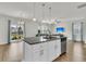 Bright living room with island kitchen, granite counters, stainless appliances, leading to outdoor patio at 9706 Fanning Basket Ln, Ladson, SC 29456