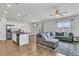 Open-concept living space boasting hardwood floors and a stylish sectional sofa at 9706 Fanning Basket Ln, Ladson, SC 29456