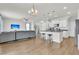 Open-concept living space with bar stool seating at a large island, transitioning into a cozy living room with comfortable seating at 9706 Fanning Basket Ln, Ladson, SC 29456