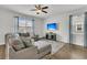 Cozy living room with plush seating, a flat-screen TV, and decorative curtains at 9706 Fanning Basket Ln, Ladson, SC 29456