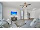 Cozy living room featuring hardwood floors, a plush sectional, and a flat-screen TV at 9706 Fanning Basket Ln, Ladson, SC 29456