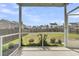Screened porch view overlooking a spacious backyard, privacy fence, lush green grass, and the surrounding neighborhood at 9706 Fanning Basket Ln, Ladson, SC 29456