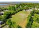 Aerial view of expansive community green space, tennis court, and lush landscaping, perfect for outdoor activities at 1 Marlow Dr, Charleston, SC 29403