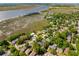 Aerial view highlighting waterfront properties, lush greenery, and neighborhood streets near the marsh at 1 Marlow Dr, Charleston, SC 29403
