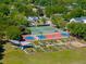 Aerial view of community amenities featuring garden, basketball, and tennis courts nestled amongst lush trees at 1 Marlow Dr, Charleston, SC 29403