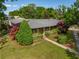 Aerial view of a well-maintained home with mature landscaping, a driveway, and a serene neighborhood setting at 1 Marlow Dr, Charleston, SC 29403