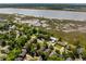 Scenic aerial view of residential homes, marshland, and waterway, enhanced by verdant trees and landscape at 1 Marlow Dr, Charleston, SC 29403