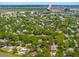 An aerial view showcases neighborhood homes amidst lush green trees and a bay in the background at 1 Marlow Dr, Charleston, SC 29403