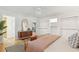 Light-filled bedroom featuring hardwood floors, a stylish dresser, and an adjacent doorway to the kitchen at 1 Marlow Dr, Charleston, SC 29403