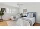 Shared bedroom with two twin beds, hardwood floors, neutral colors, and bright, natural light at 1 Marlow Dr, Charleston, SC 29403
