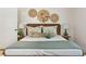 Bedroom with rattan bed frame, textured pillows, decorative baskets, and bright lamps at 1 Marlow Dr, Charleston, SC 29403