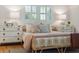 Close-up of bright bedroom featuring a unique bed frame, stylish decor, and natural light from windows at 1 Marlow Dr, Charleston, SC 29403