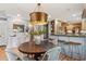Stylish dining area with modern lighting and a view of the updated kitchen, perfect for entertaining guests at 1 Marlow Dr, Charleston, SC 29403