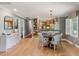Bright dining room featuring hardwood floors, modern lighting, and easy access to the updated kitchen at 1 Marlow Dr, Charleston, SC 29403
