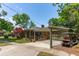 Charming home with brick accents, a pergola-covered driveway, and a well-manicured front yard under a blue sky at 1 Marlow Dr, Charleston, SC 29403