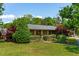 Beautiful home exterior with lush landscaping, mature trees, and a well-maintained lawn at 1 Marlow Dr, Charleston, SC 29403