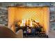 Close up of fireplace with decorative brickwork and a warm, inviting fire burning at 1 Marlow Dr, Charleston, SC 29403