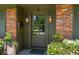 Detailed view of the home's front door with sidelights and brick accents at 1 Marlow Dr, Charleston, SC 29403