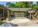 Attached garage with pergola covered parking, brick accents, and driveway, blending style with functionality at 1 Marlow Dr, Charleston, SC 29403