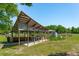 Community garden pavilion surrounded by flourishing greenery and raised garden beds at 1 Marlow Dr, Charleston, SC 29403