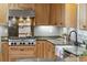 Bright kitchen featuring wooden cabinets, green marble countertops, and stainless steel appliances at 1 Marlow Dr, Charleston, SC 29403