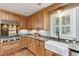 Elegant kitchen featuring custom cabinets, modern appliances, and a farmhouse sink with backyard view at 1 Marlow Dr, Charleston, SC 29403